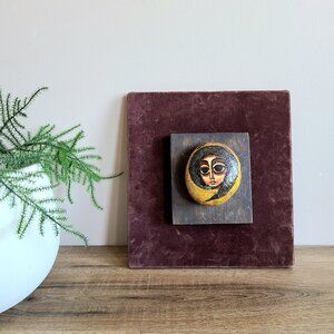 Handmade painting on rock. Face painting. 3D art.